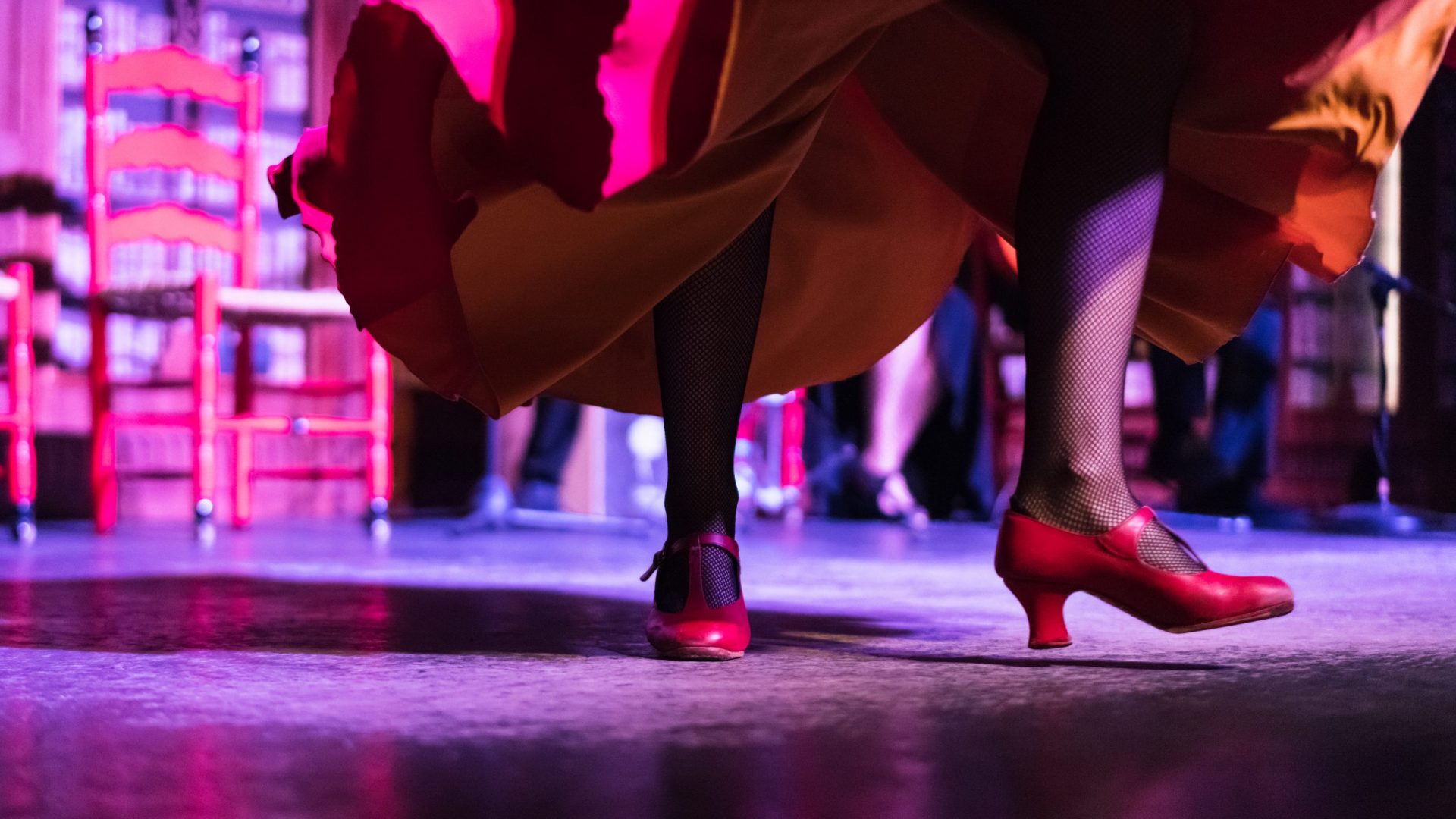 Closeup of the legs and red shoes of a flamenko dancer whilst she's dancing on the stage in Palma de Mallorca, Spain