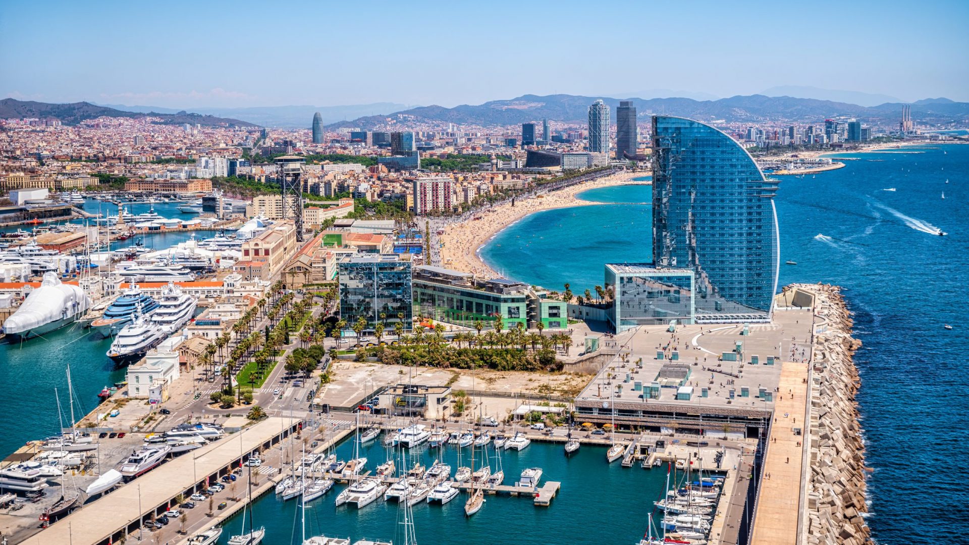 Front of Barcelona from the air with the port vell, the business center and the hotel
