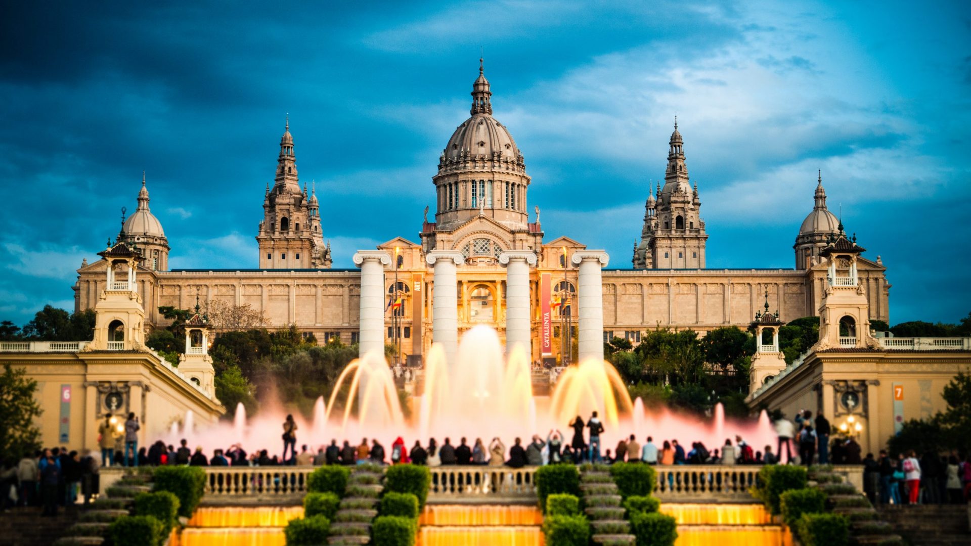"Tourists watching colorful fountain Font MA gica show at Montjuic MNAC. Barcelona, Catalonia, Spain."