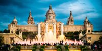 "Tourists watching colorful fountain Font MA gica show at Montjuic MNAC. Barcelona, Catalonia, Spain."